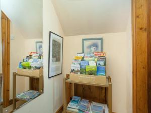 a room with shelves filled with books at Wheal Trenwith Cottage in St Ives