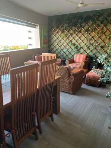 a living room with two chairs and a table and a wine cellar at Chez Carole in Rose Hill