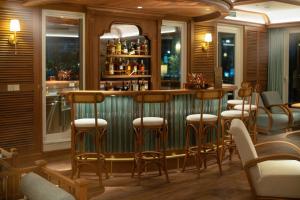 a bar in a restaurant with stools at Bhaya Soul - Wellness Inclusive Cruise in Ha Long