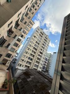 a view of two tall buildings in a city at Pé na Areia Praia do Gonzaguinha II in São Vicente