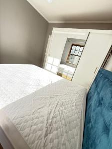 a bedroom with a large bed and a window at Pé na Areia Praia do Gonzaguinha II in São Vicente