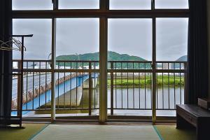 a view of a bridge from a room with a window at hotorino in Numazu