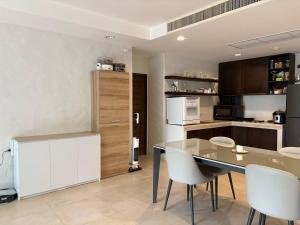 a kitchen with a dining table and white chairs at Playa Hua Hin 3BR Oceanfront in Khao Tao