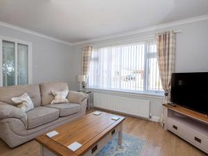 a living room with a couch and a coffee table at Raasay in Dornoch