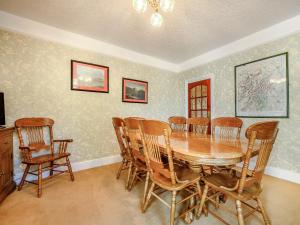 a dining room with a wooden table and chairs at Greenbank in Keswick
