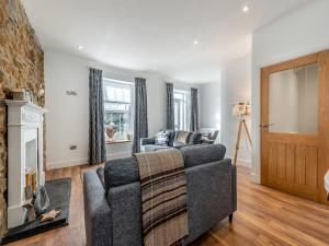 a living room with a couch and a fireplace at Beachey View - Uk43058 in Saundersfoot