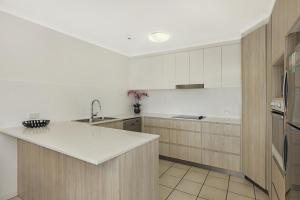 a kitchen with a sink and a counter top at Elouera Tower in Maroochydore