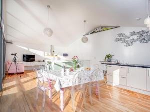 a dining room with a white table and chairs at Lookout in Downderry +33 photos