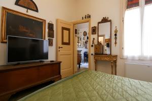 a bedroom with a flat screen tv and a bed at B&B Fuori Dai Coppi - Bologna in Bologna