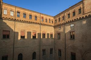 a large brick building with many windows on it at B&B Fuori Dai Coppi - Bologna in Bologna