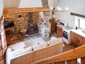 an overhead view of a kitchen with a stone fireplace at Ty Tarw - Uk46189 in Llanybydder