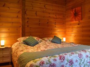 a bedroom with a bed with wooden walls at Bluebell -Uk48309 in Staintondale