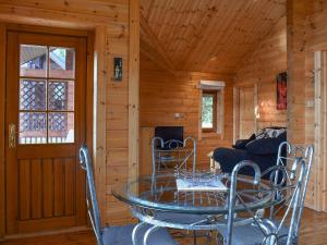 a dining room with a glass table and chairs at Bluebell -Uk48309 in Staintondale