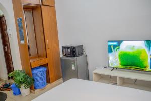 a room with a television and a picture of a fish at Serene Apartments - studio 001 in Mombasa