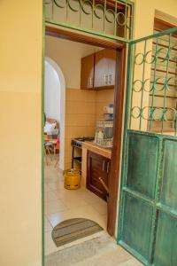 a kitchen with an open door to a kitchen with a stove at Serene Apartments - studio 001 in Mombasa