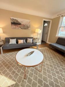 a living room with a couch and a coffee table at Entire Two Bedrooms Bungalow- Walking distance to Burlington Downtown- Sleeps 6 in Burlington