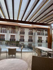 a patio with tables and chairs and a building at Pyrineus Residence - Resort em Pirenópolis in Pirenópolis +17 photos
