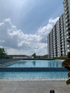a large swimming pool in front of some buildings at Latte Homestay Desaru 5GWifi with Swimming Pool in Bandar Penawar