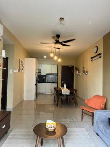 a living room with a couch and a ceiling fan at Latte Homestay Desaru 5GWifi with Swimming Pool in Bandar Penawar