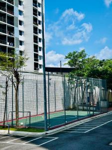 a tennis court in front of a building at Latte Homestay Desaru 5GWifi with Swimming Pool in Bandar Penawar