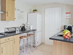 a kitchen with a sink and a refrigerator at Mill View House in Scarborough