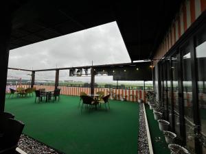 a patio with tables and chairs on a building at Friendship On Hotel Wink in Angeles