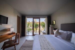 a bedroom with a bed and a view of a patio at Anam Tang New Rooms & Cafe near Seminyak in Seminyak +27 photos