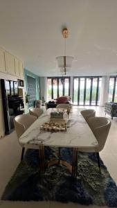 a living room with a table and chairs at Aimo Villa in Ciburial