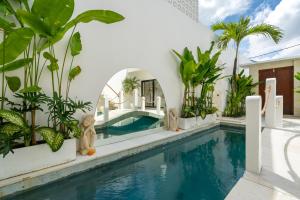 a swimming pool in a villa with plants at Villa Romance in Tumbak Bayuh +117 photos