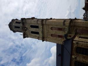 a building with a clock on the side of it at Hotel La Barakka in Lokeren