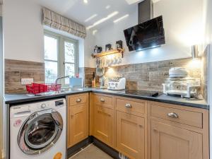 a kitchen with a washer and a washing machine at The Studio in Woolland