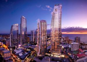 a group of tall buildings in a city at night at Geometry of Water - Luxury Bauhaus by the Canal in Gold Coast