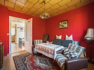 a living room with red walls and a couch at Countryside Stay in Meisdorf in Meisdorf