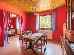 a dining room with red walls and a table and chairs at Countryside Stay in Meisdorf in Meisdorf +19 photos