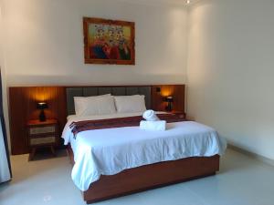 a bedroom with a bed with a teddy bear on it at Artha Sadia Villa 1 Seseh Beach in Cemagi +38 photos