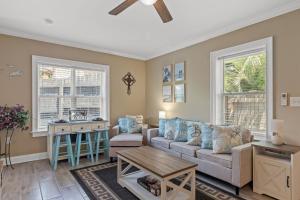 a living room with a couch and a table at Historic Downtown Waterfront Access Near Beach in Panama City Beach