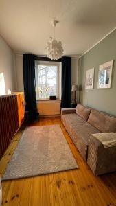 a living room with a couch and a window at Ferienwohnung inmitten der Natur und Seen in Haltern