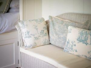 two pillows sitting on top of a couch at Helen's Shepherds Hut in Enford