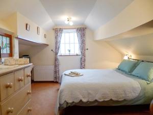 a bedroom with a large bed and a sink at The Old Coach House in Burythorpe