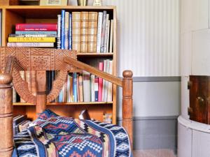 a book shelf filled with books next to a bed at 11 person holiday home in STORA SUNDBY in Böcklinge +25 photos