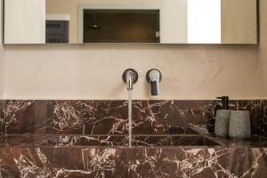 a kitchen with a sink with a faucet at Ano Kampos Hotel in Faliraki +11 photos