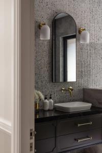 a bathroom with a sink and a mirror at Cinque House - Close to Berry in Coolangatta +34 photos