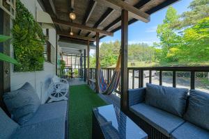 a screened in porch with blue couches and a table at Private hot-spring Villa in Kusatsu #projector in Kusatsu