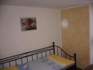 a bedroom with a bed and a painting on the wall at Ferienhaus in Waren an der Müritz in Waren