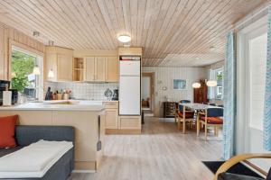 a kitchen and living room with a couch and a table at Cozy Holiday Home Close To The Beach in Thyholm