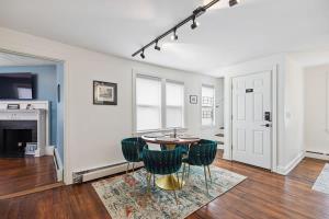 a living room with a table and green chairs at Federal Hill PRIDE in Providence