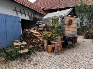 a building with a pile of fire wood next to a house at Familyroom 6 P Free WiFi Gemeinschaftsbad in Hausbreitenbach +4 photos
