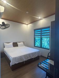 a bedroom with a large bed and a window at BamBoo Villa Homestay in Ninh Binh