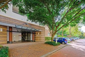 a building with a car parked in front of it at Redfern 2Br Near CBD Shopping Center with Pool & Gym in Sydney