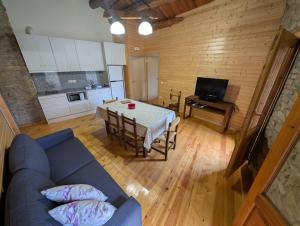 a living room with a blue couch and a table at Rustic charm in Àger, a natural paradise in Àger